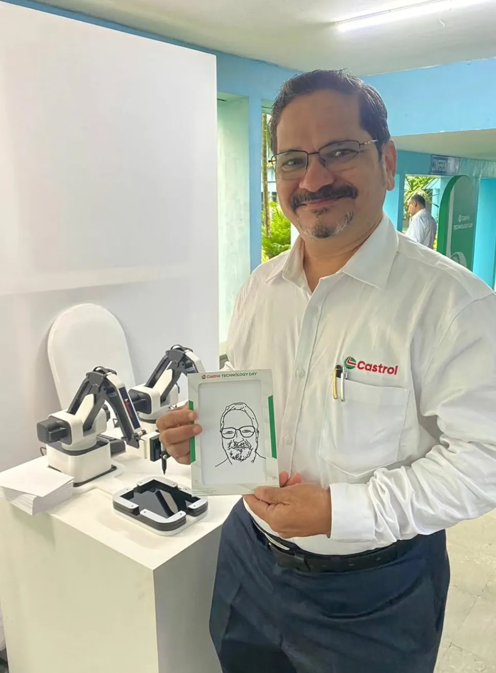 Robotic sketchbot drawing a live portrait at a corporate technology day