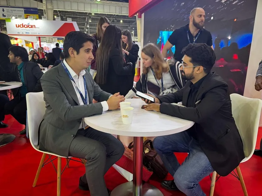 B2B buyer meeting at an international travel trade show pavilion
